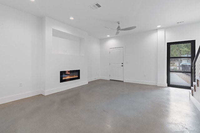 unfurnished living room featuring concrete flooring and ceiling fan