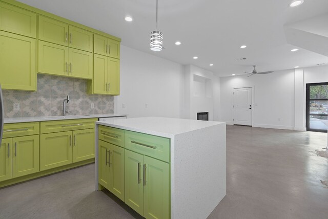 kitchen featuring concrete flooring, decorative light fixtures, a center island, ceiling fan, and decorative backsplash