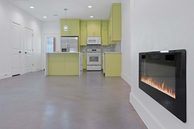 kitchen featuring pendant lighting, white appliances, and backsplash