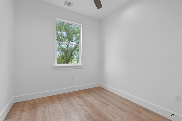 unfurnished room with light wood finished floors, baseboards, visible vents, and ceiling fan