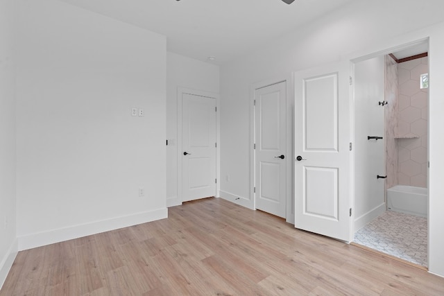 unfurnished bedroom featuring light wood-style flooring and baseboards