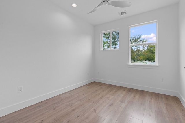 unfurnished room featuring light wood finished floors, recessed lighting, visible vents, ceiling fan, and baseboards