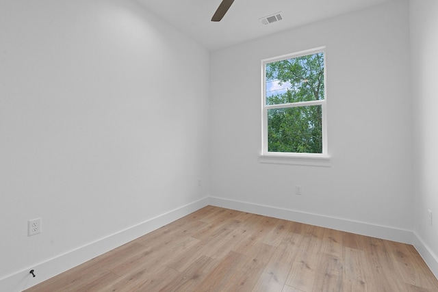 unfurnished room featuring visible vents, ceiling fan, light wood finished floors, and baseboards