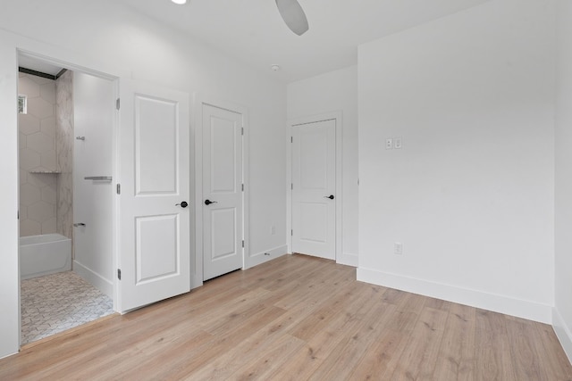 unfurnished bedroom with light wood-type flooring, connected bathroom, and baseboards