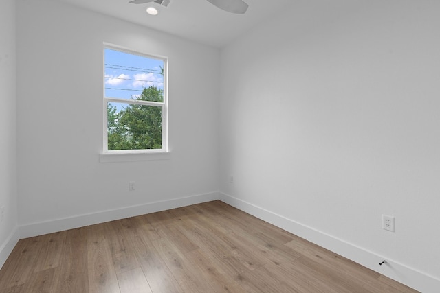 unfurnished room with light wood-type flooring, ceiling fan, and baseboards