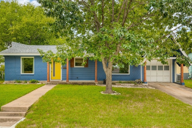 view of front of house with a front yard and a garage