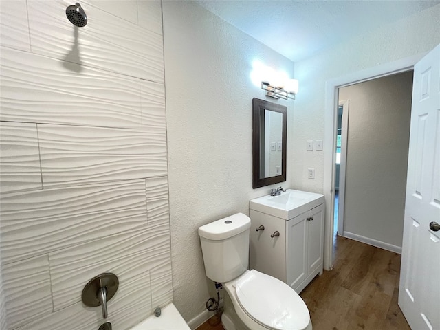 bathroom featuring vanity, hardwood / wood-style flooring, and toilet