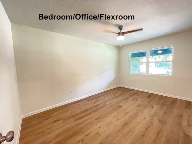 empty room with light hardwood / wood-style floors and ceiling fan