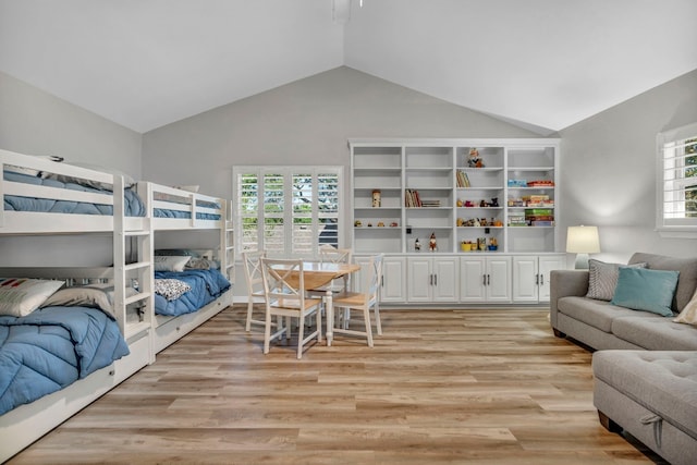 bedroom featuring multiple windows, vaulted ceiling, and light hardwood / wood-style floors