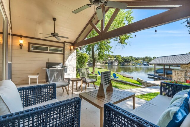 view of patio / terrace with an outdoor living space, a water view, and ceiling fan