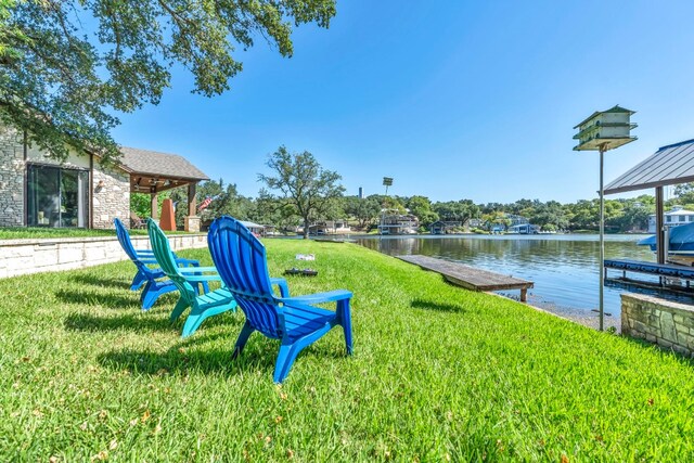 view of yard with a boat dock and a water view