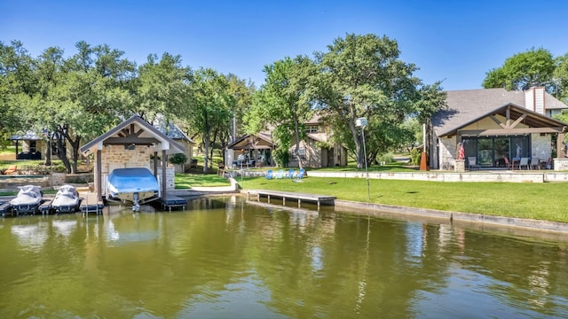 view of dock with a water view and a yard