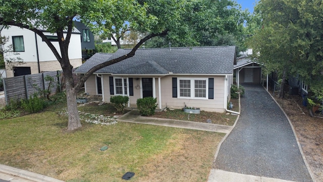 view of front of property with a front yard and a storage shed