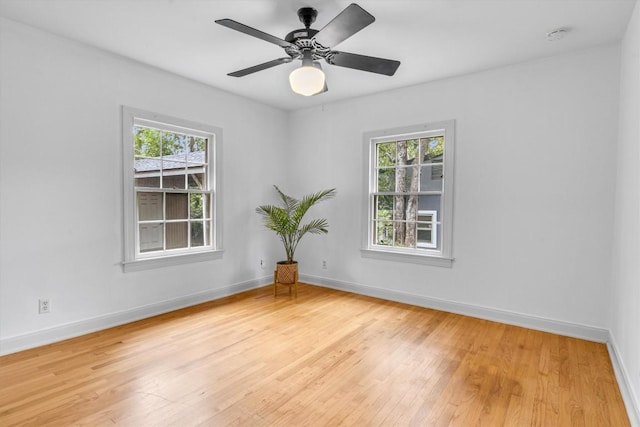 unfurnished room with light wood-type flooring, plenty of natural light, and ceiling fan