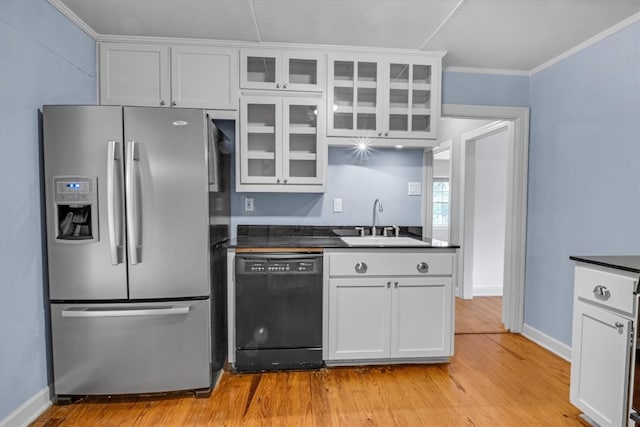 kitchen with white cabinetry, sink, dishwasher, and stainless steel refrigerator with ice dispenser