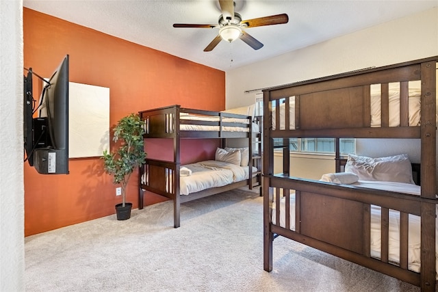 bedroom featuring a textured ceiling, ceiling fan, and carpet flooring