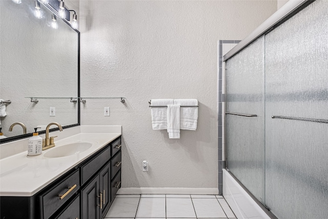 bathroom featuring combined bath / shower with glass door, vanity, and tile patterned flooring