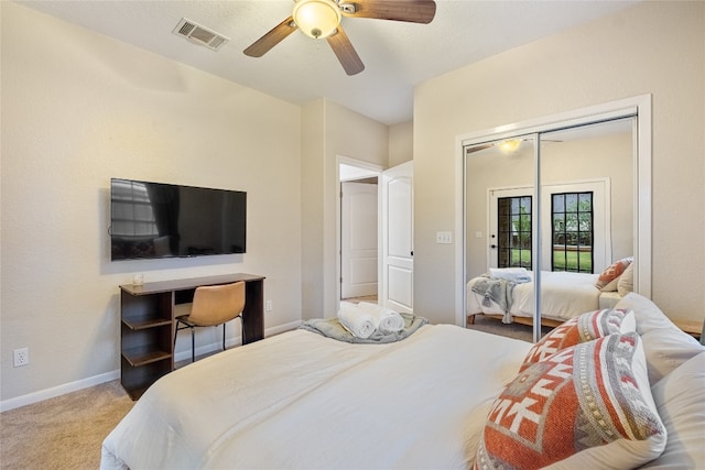 carpeted bedroom featuring ceiling fan and a closet