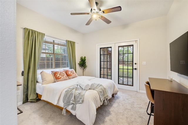 bedroom featuring multiple windows, ceiling fan, light colored carpet, and access to outside