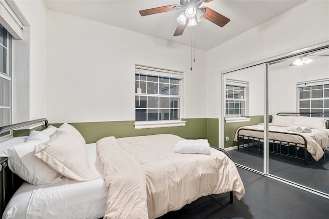 bedroom with ceiling fan and a closet