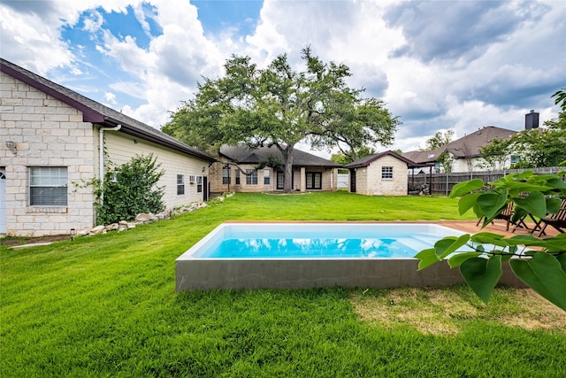 view of swimming pool with a lawn