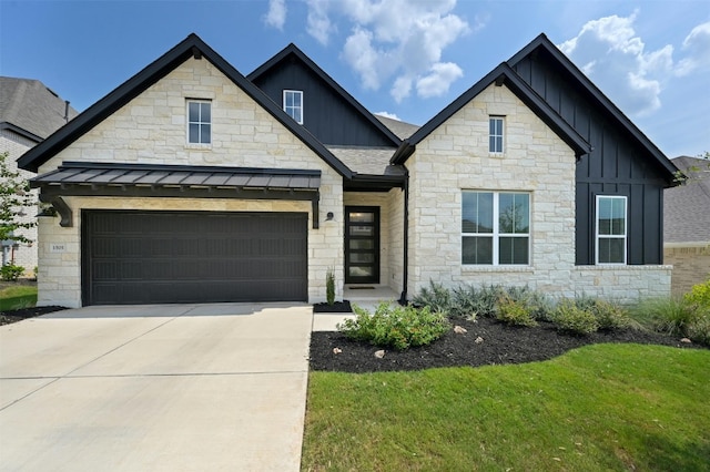 view of front of house featuring a standing seam roof, concrete driveway, a garage, board and batten siding, and metal roof