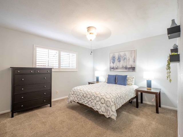 bedroom with ceiling fan and light colored carpet