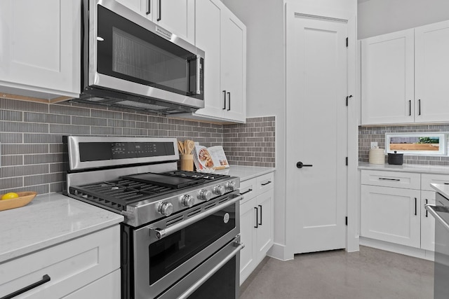5511 William Holland Ave Unit 2, Austin, TX 78756 - kitchen with appliances with stainless steel finishes, decorative backsplash, white cabinetry, light stone counters, and concrete flooring