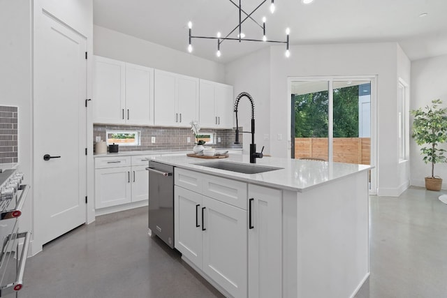 kitchen with backsplash, a sink, concrete floors, white cabinetry, and stainless steel dishwasher