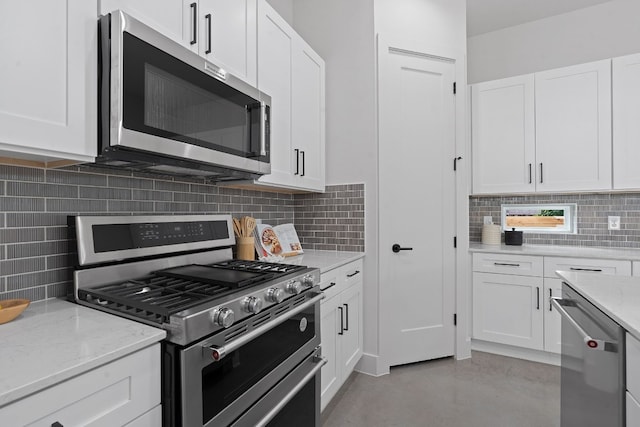 kitchen with stainless steel appliances, white cabinets, and decorative backsplash