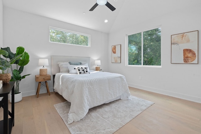 bedroom with vaulted ceiling, a ceiling fan, light wood-style flooring, and baseboards