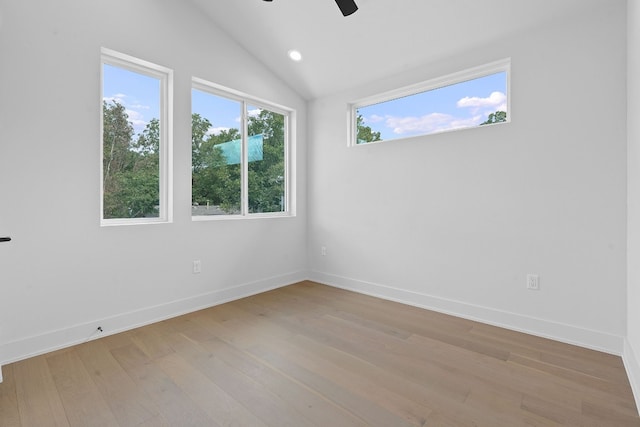 unfurnished room featuring ceiling fan, light wood-style flooring, baseboards, and vaulted ceiling