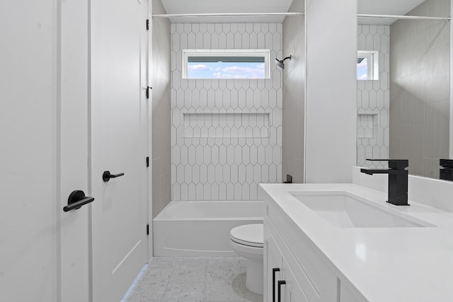 bathroom featuring washtub / shower combination, plenty of natural light, vanity, and toilet