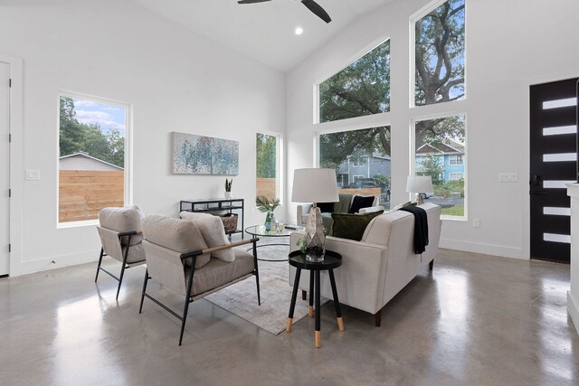 living room with high vaulted ceiling, concrete flooring, and ceiling fan