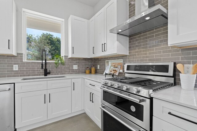 kitchen with sink, white dishwasher, gas range, white cabinets, and wall chimney range hood