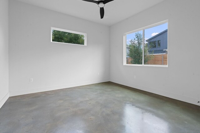 spare room with concrete flooring and ceiling fan