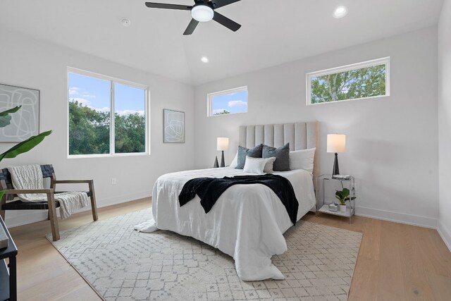 bedroom featuring multiple windows, ceiling fan, and light hardwood / wood-style floors