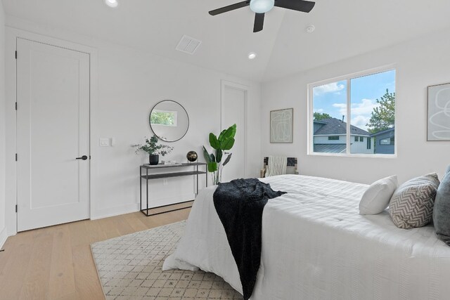 bedroom with light hardwood / wood-style flooring, ceiling fan, and vaulted ceiling