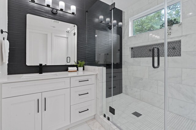 bathroom featuring an enclosed shower and vanity