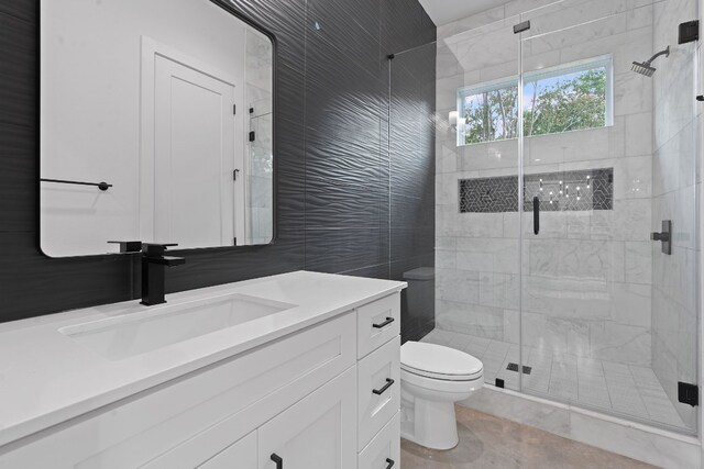 bathroom with vanity, toilet, and an enclosed shower