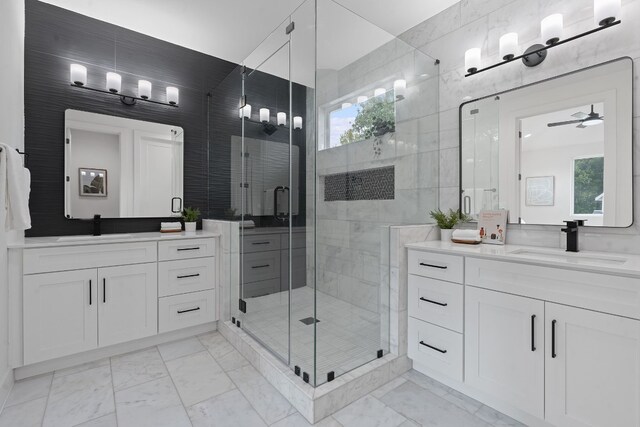 bathroom featuring vanity, tile walls, a shower with shower door, and ceiling fan