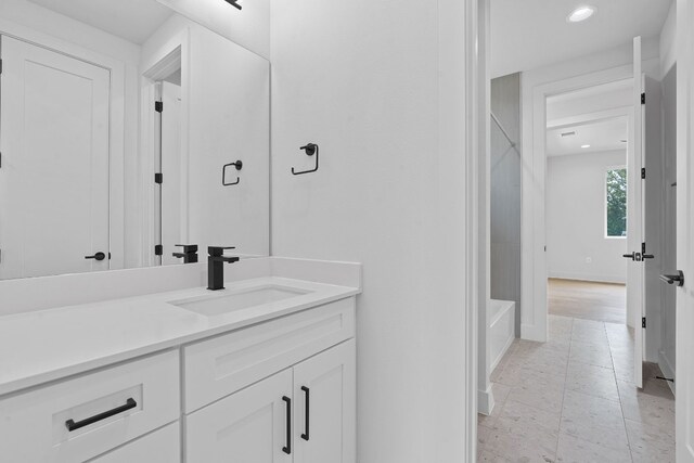 bathroom featuring a tub and vanity