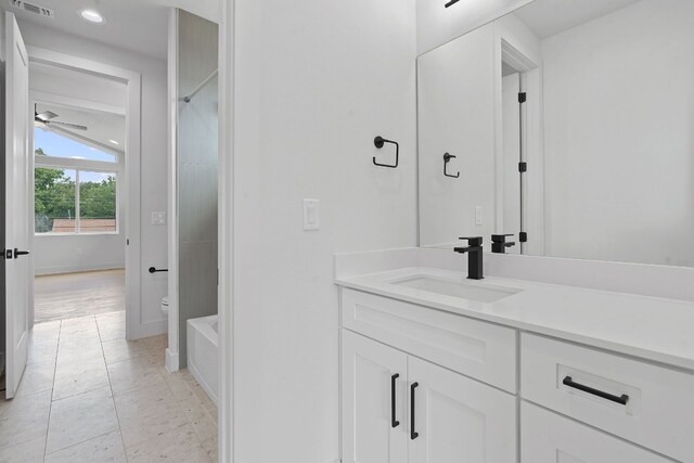 full bathroom with vanity, separate shower and tub, toilet, tile patterned floors, and ceiling fan