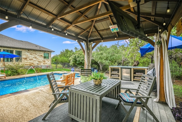 view of patio with a gazebo, a bar, fence, and an outdoor pool