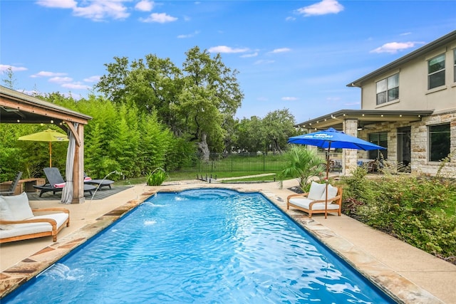 view of pool with pool water feature and a patio