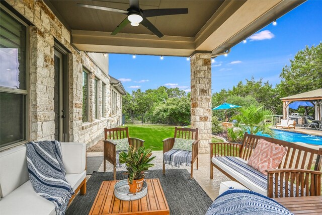 view of patio / terrace with an outdoor pool, an outdoor hangout area, a ceiling fan, and a gazebo