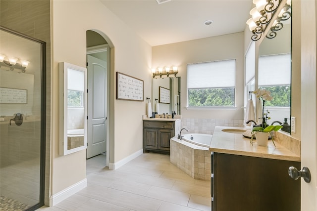 bathroom with vanity, independent shower and bath, and tile patterned flooring