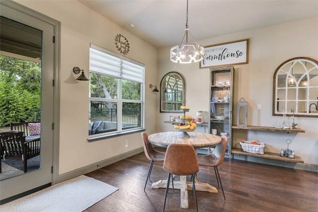 dining room featuring dark wood-type flooring and a chandelier