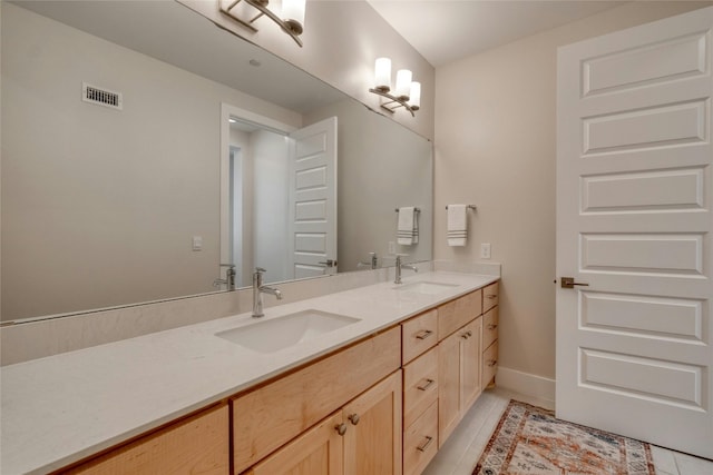 4209 Elevator Dr, Austin, TX 78731 - full bath with double vanity, tile patterned flooring, and baseboards