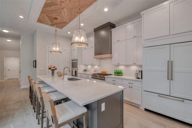 4209 Elevator Dr, Austin, TX 78731 - kitchen with stainless steel appliances, a sink, light wood-type flooring, recessed lighting, and light countertops